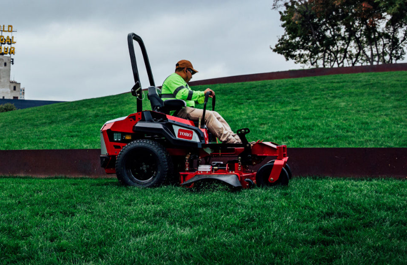 A man uses a Toro Z Master Revolution from Kenney Machinery to mow a lawn.